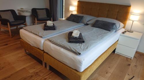 a large bed with two phones on top of it at Penzion Kůlna in Slatiňany