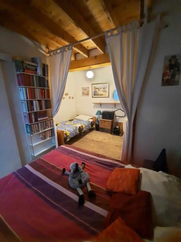 Cette chambre comprend un lit avec un animal farci. dans l'établissement Maison de vacances, à Chambon-le-Château