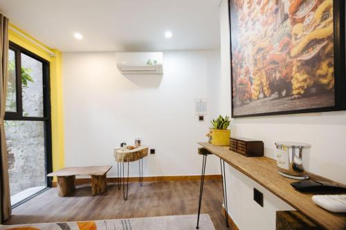 a room with a table and a painting on the wall at Rik Homestay in Hanoi