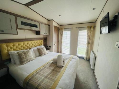 a bedroom with a large bed in a room at Lakeside Escape with Hot Tub in York