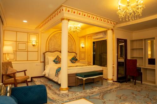 a bedroom with a canopy bed and a chandelier at G Ramayana in Kathmandu