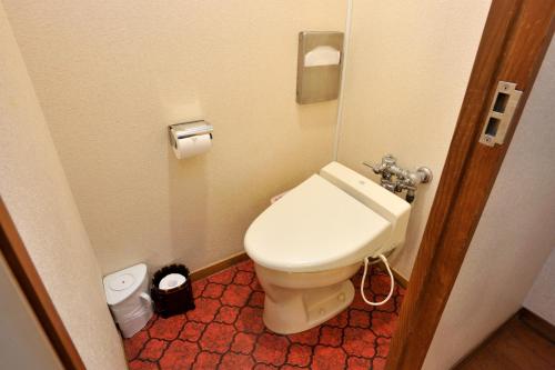 a bathroom with a white toilet in a room at Fukeikan 風景館 in Takayama