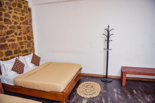 a small bedroom with a bed and a bench at The Residence Ella in Ella