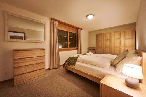 a bedroom with a large bed and a window at Apartment Mountain View, Luxury, Spacious with best Views in Lauterbrunnen