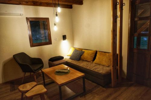a living room with a couch and a table at Apartmani Novakovic in Bajina Bašta
