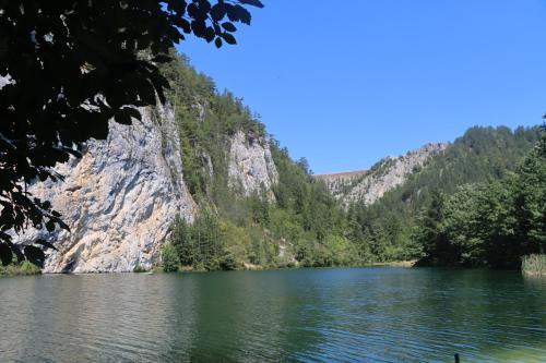 a view of a lake in front of a mountain at Apartmani Novakovic in Bajina Bašta