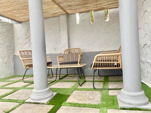 a group of chairs and a table on a patio at Pistachio villa in Durban