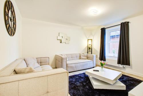 a living room with a couch and a table at Entire house in Stanway, Colchester in Colchester