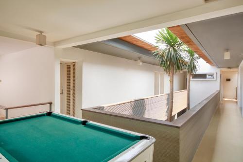 a pool table in a room with a balcony at FLAT06 cipete in Jakarta