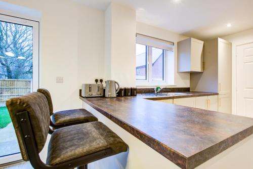 a kitchen with a large counter and a window at Entire house in Stanway, Colchester in Colchester