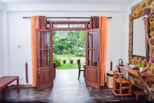an open door in a room with a table and a mirror at The Residence Ella in Ella