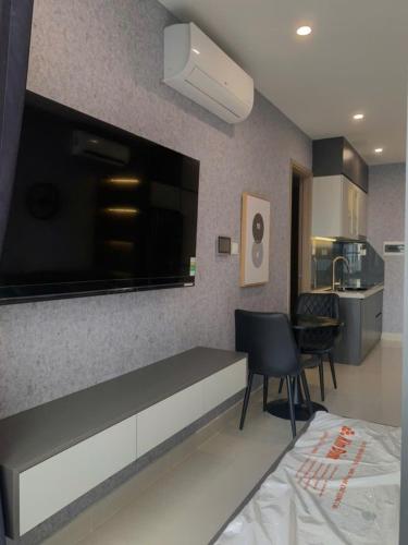a living room with a large flat screen tv on a wall at CĂN HỘ VINHOMES GRAND PARK QUẬN 9 Studio in Gò Công