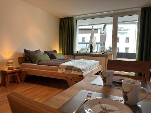 a bedroom with a bed and a large window at Hirschzauber A9 Montana Haus in Oberstdorf