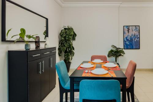 a dining room with a table and chairs at Distinct & Decent 2 BDR Apt Steps From Nightlife and Airport in Cairo