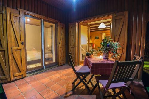 a dining room with a table and chairs on a patio at Quinta dos Curubas in Vila Franca do Campo
