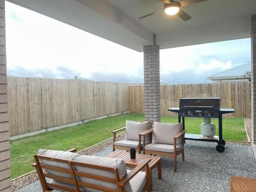 a patio with chairs and a grill and a piano at Enchanting Griffin Retreat Memorable Stay Awaits in Griffin