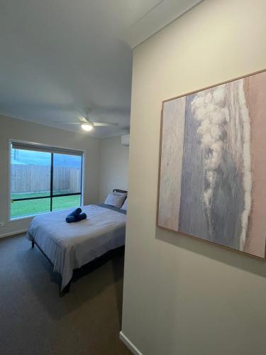 a bedroom with a bed and a painting on the wall at Enchanting Griffin Retreat Memorable Stay Awaits in Griffin