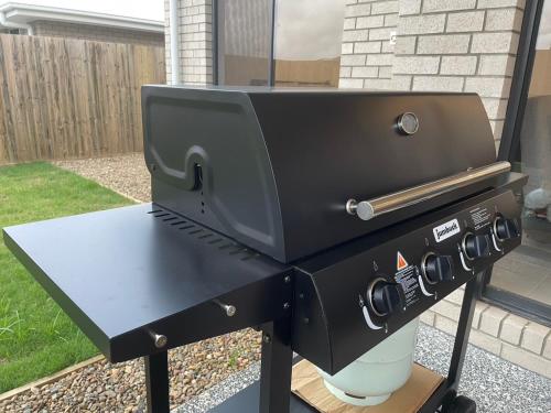 a bbq grill sitting on top of a table at Enchanting Griffin Retreat Memorable Stay Awaits in Griffin