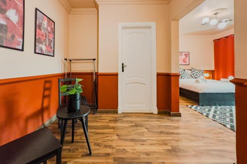 a room with a door and a table and a bed at Distinct & Decent 2 BDR Apt Steps From Nightlife and Airport in Cairo
