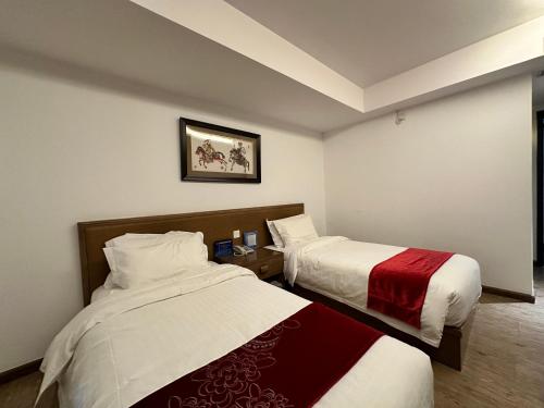 a hotel room with two beds in a room at Beijing Shichahai Shadow Art Performance Courtyard in Beijing