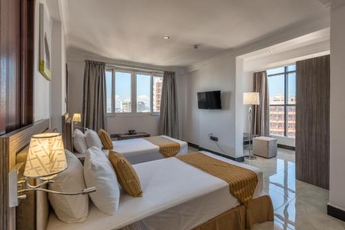 Krevet ili kreveti u jedinici u okviru objekta Golden Tulip Dar Es Salaam City Center Hotel