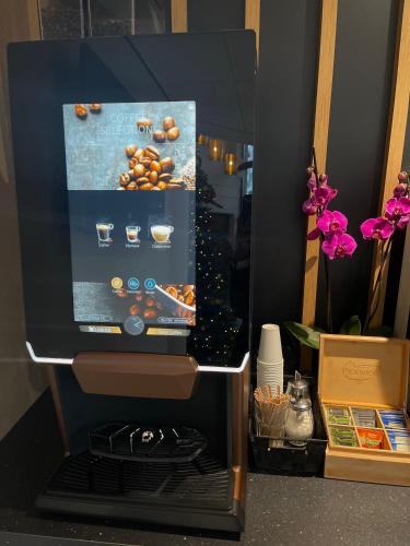 a microwave oven with a picture of food at OZO Hotels Antares Airport in Hoofddorp