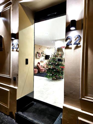 a mirror in a lobby with a christmas tree in a room at Hotel Agenor in Paris