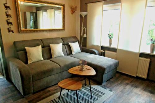 a living room with a couch and a table at FeWo Schwedenhaus in Eschede