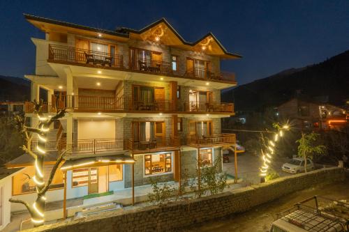 a large building with lights on it at night at Hotel Country Side Manali in Vashisht