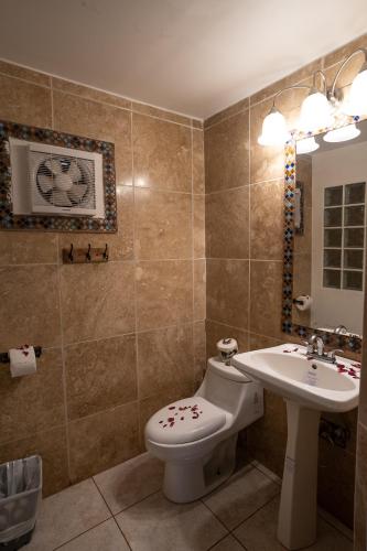 a bathroom with a toilet and a sink at mame trees in West End