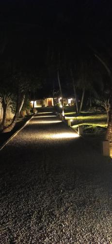 a dark road at night with trees and lights at Villa Greenjay Ahangama in Ahangama