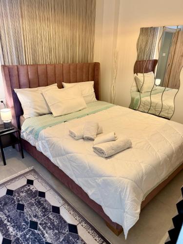a bedroom with a large bed with towels on it at Casa dell'Arte & Quiet Area & Free Parking in Volos