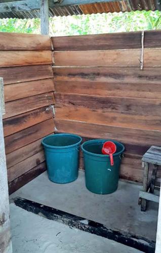 two buckets sitting next to a wooden wall at Yefkabu Homestay Raja Ampat in Waisai