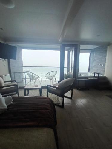 a living room with a view of the ocean at Departamento jacuzzi 1 en Valdivia in Valdivia