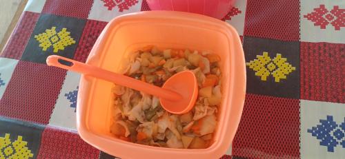 a plastic container filled with food with a spoon in it at Yefkabu Homestay Raja Ampat in Waisai