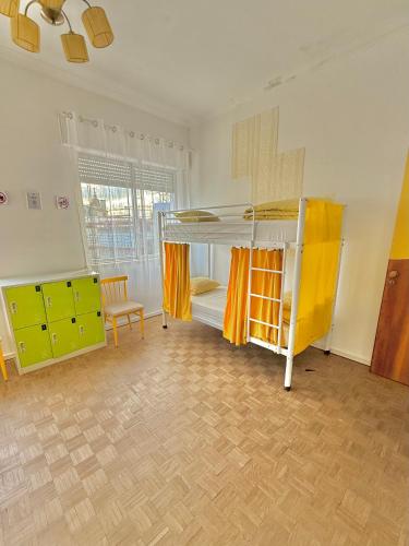 a room with two bunk beds and a chair at Barão 35 Guest House in Braga