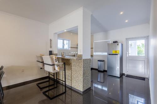ウィレムスタッドにあるGrey Apartmentsの白いキッチン(カウンター、冷蔵庫付)