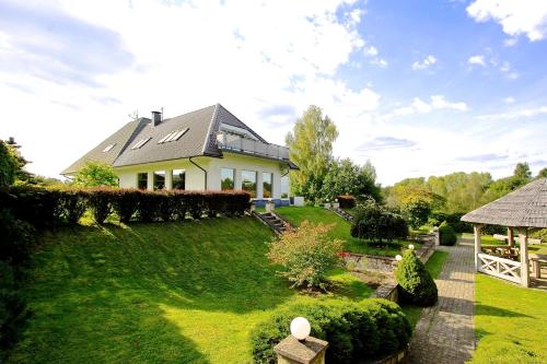 a house with a garden and a fence at Jaunkrastmaļi in Kandava