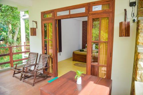 a room with a table and chairs on a balcony at The Residence Ella in Ella