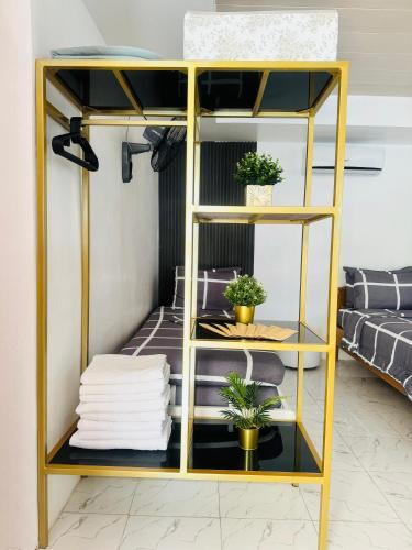 a yellow bunk bed in a room with potted plants at VickyBella's FUNadise Private Resort in Cauayan