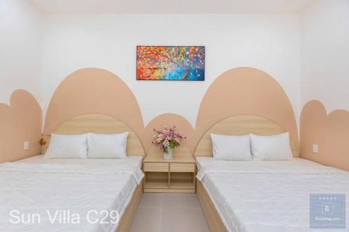 two beds sitting next to each other in a room at C29 Đi Bộ Ra Biển - Trệt Không Lầu - Free Bida - Loa Karaoke in Vung Tau