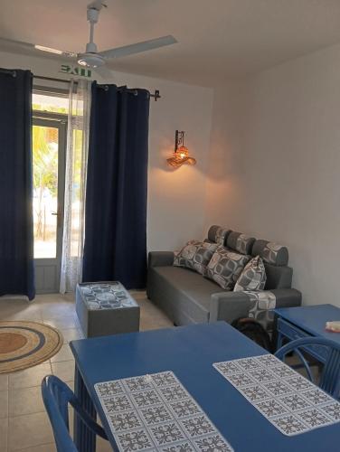 a living room with a couch and blue tables at Exotica Sense in Flic-en-Flac