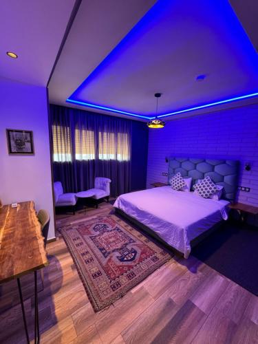 a bedroom with a large bed with a blue lighting at Maurice Bonjean in Ifrane