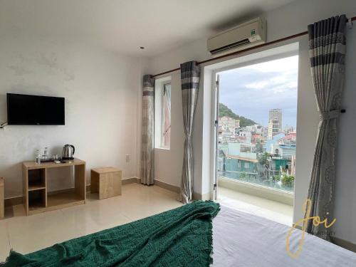 a bedroom with a large window with a view at Joi Hospitality - Anthony in Vung Tau