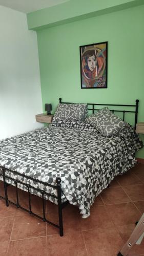 a bed with a black and white comforter in a bedroom at Il Tulipano in Chieri