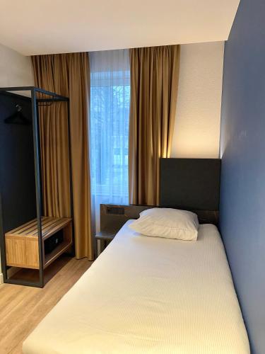 a hotel room with a bed and a window at OZO Hotels Antares Airport in Hoofddorp