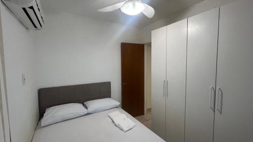 a bedroom with a bed and a white cabinet at Descanso e Tranquilidade em Guaratiba in Rio de Janeiro