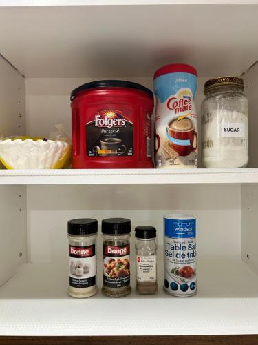 a refrigerator shelf with various food items in it at Super Cosy Peaceful room with Garden view free Parking in Toronto