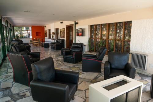 a waiting room with black chairs and a table at Italia in La Falda