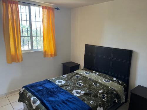 a bedroom with a bed and a window at Departamento Entero en el Sur Facturamod in Santa Gertrudis